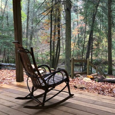 A rocking chair facing the woods.