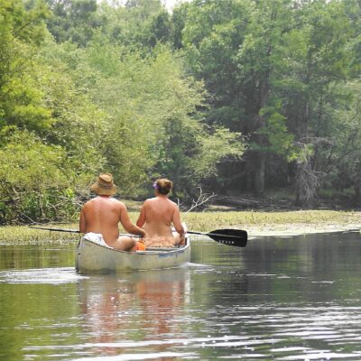 Naturists enjoying a canoe ride.