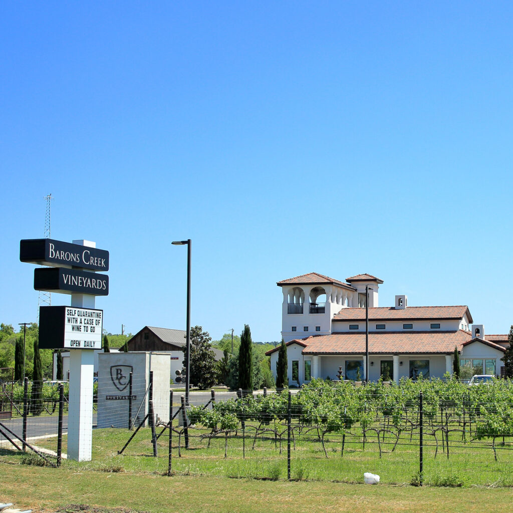 A sign advertising Barons Creek Vineyards along Highway 290 Wine Trail.